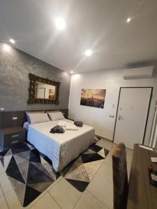 a bedroom with a bed and a mirror on the wall at Foresterie Lombarde B&B Villa Ambra in Limbiate +128 photos