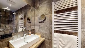a bathroom with a sink and a mirror at Haus Lina in Sankt Anton am Arlberg +5 photos