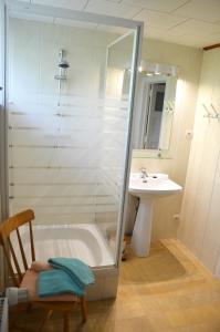 a bathroom with a shower and a sink and a tub at Gite La Brasserie Sivry in Sivry