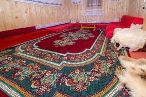 two sheep standing in a living room with a rug at Sustainable Samel's Cottage Hrid's lake Prokletije in Plav