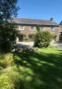 a large brick house with a large yard at The Mews, Talley in Llandeilo