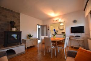 a living room with a dining room table and a television at Apartments Frkovic in Ledenice