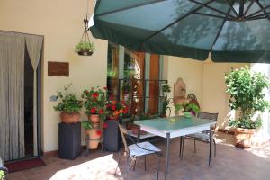 a patio with a table and some potted plants at Casa le Betulle in Montespertoli