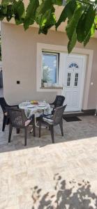 a patio with a table and chairs and a door at Apartments Zdenka in Labin