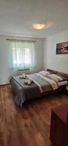 a bedroom with a large bed with two towels on it at Apartments Zdenka in Labin