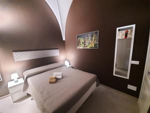a small bedroom with a bed and a mirror at Zia Nennè Holiday Rooms in Monopoli