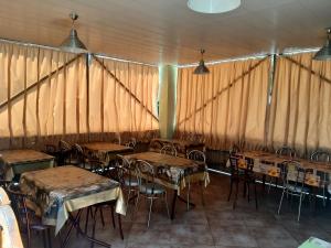 a group of tables and chairs in a tent at Зюйд in Gribovka