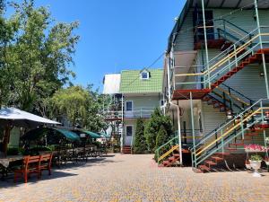 a patio with tables and chairs next to a building at Зюйд in Gribovka