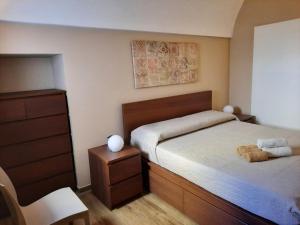 a bedroom with a bed with a teddy bear on it at Zia Nennè Holiday Rooms in Monopoli