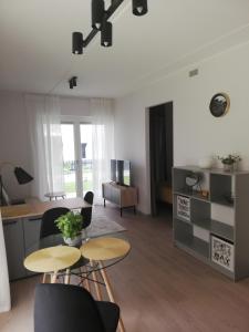 a living room with two tables and chairs at Kalamaja Garden in Tallinn