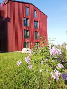 a red building with flowers in front of it at Kalamaja Garden in Tallinn