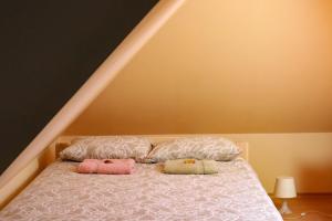 a bed with two pillows on top of it at Maria Apartment Tolli põik in Kuressaare