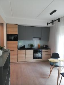 a large kitchen with wooden cabinets and a table at Kalamaja Garden in Tallinn