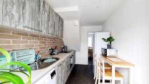 a kitchen with a sink and a counter at Station Heights in Rayleigh