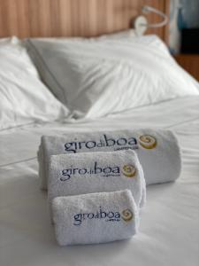 three towels sitting on top of a bed at B&B Giro Di Boa in Lampedusa