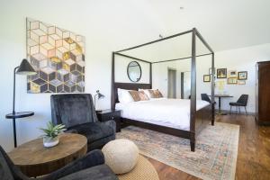 a bedroom with a bed and a chair and a table at The Setting Inn Willamette Valley in Newberg