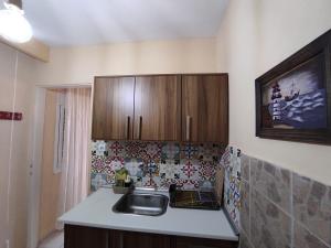 a kitchen with a sink and wooden cabinets at Casa Stella in Agia Triada