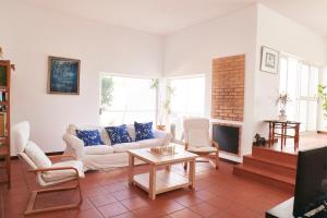 a living room with a couch and a fireplace at Villa Lua Mar in Fuzeta