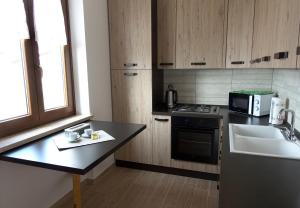 a kitchen with a counter and a sink and a microwave at Casa Giuditta in Torri del Benaco