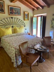 a bedroom with a large bed and a table and chairs at The Queen Tower in Desenzano del Garda
