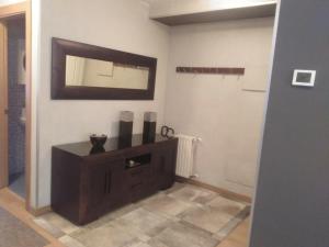 a bathroom with a vanity and a mirror on the wall at Casa Pimen in Gijón