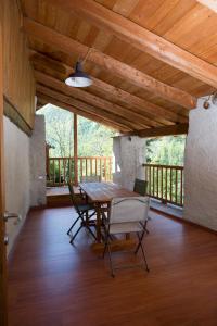 a dining room with a table and chairs on a wooden floor at AlfaBaita in Sampeyre