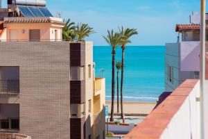 a view of the beach from the balcony of a building at Apartamento CA VALEN 1 in Peniscola