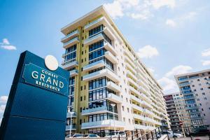 a large building with a sign in front of it at Dina Lux Iasi Apartment in Iaşi