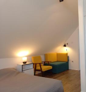 1 dormitorio con 1 cama, 2 sillas y mesa en Diókert Vendégház Sopron en Sopron