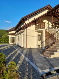 a house with a staircase in front of it at Vila Miorita in Sebeş