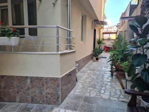 a balcony with plants on the side of a building at Guest Rooms Kostovi in Nesebar