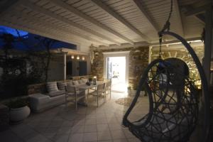 a patio with a table and chairs and a table at ThalaSEA - village Antiparos in Antiparos