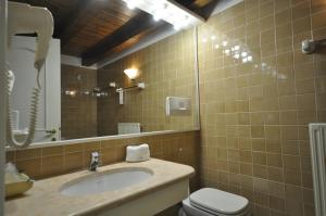 ガッリオにあるHotel La Lepre Biancaのバスルーム(洗面台、トイレ、鏡付)