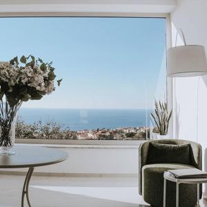 a living room with a table and a large window at Tenuta Tropeano in Tropea