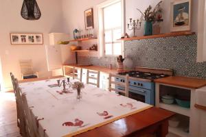 a kitchen with a table and a stove top oven at House No1 in Nieu-Bethesda