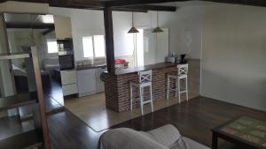 a living room with a kitchen with a counter and a living room at Moderno Loft en Urb La Marina in San Fulgencio +5 photos