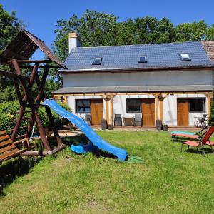 a playground with a slide in the yard of a house at U Jarka in Smołdziński Las