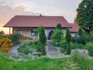 a house with a garden in front of it at Apartament Panorama in Jeżów Sudecki