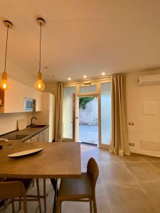 a kitchen with a table and chairs in a room at Enjoy Olbia in Olbia