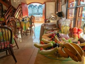 a table with a bunch of fruit on it at Pousada da Lua in Campos do Jordão