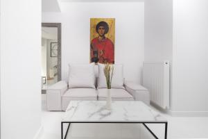 a living room with a white couch and a table at Clock Tower Arachova in Arachova