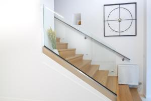 a staircase in a house with a clock on the wall at Clock Tower Arachova in Arachova +30 photos
