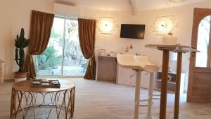 a living room with a table and some chairs at Studio villa château Currault in Mougins
