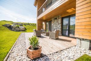 a wooden deck with chairs on a house at Apartmány Tatry Žiarce in Liptovský Mikuláš