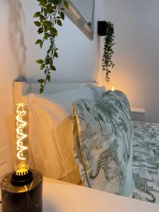 a bedroom with a bed and a lamp on a table at Dream Recova in Santa Cruz de Tenerife