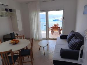 a living room with a couch and a table at Bella Vista in Komarna +53 photos