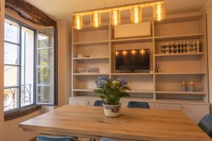 a dining room with a table and a tv at Cà Piodèe in Faggeto Lario 