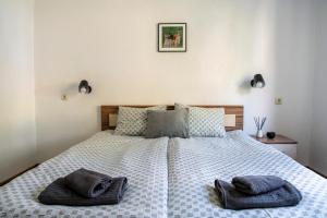 a bedroom with a bed with two towels on it at Къща До Гората Триград in Trigrad