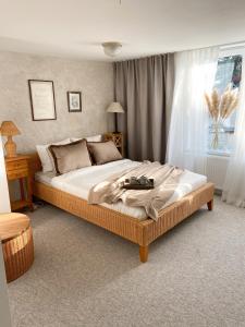 Un dormitorio con una cama con una maleta. en Naktakės apartamentai, en Kupiškis