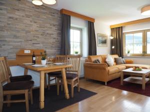 a living room with a couch and a table at Appartmenthaus Moos Bäu in Lam